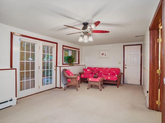 sitting room featuring carpet, a ceiling fan, and a baseboard radiator