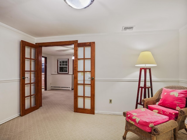 living area featuring french doors, carpet floors, a baseboard heating unit, crown molding, and baseboards