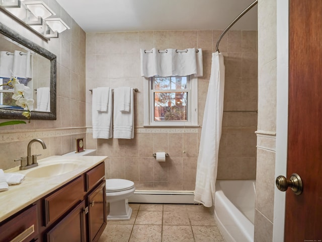bathroom featuring a baseboard heating unit, tile walls, toilet, vanity, and shower / tub combo with curtain