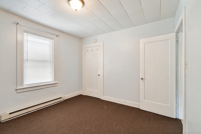 14 Palmer St, Killingly, CT 06239 - empty room with baseboard heating, crown molding, and dark carpet