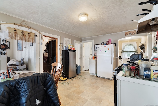 14 Palmer St, Killingly, CT 06239 - kitchen with freestanding refrigerator, crown molding, black gas stove, and open floor plan