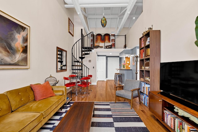 4 Coggswell St Unit 2, Stonington, CT 06379 - living area with wood finished floors, stairway, a towering ceiling, and beamed ceiling