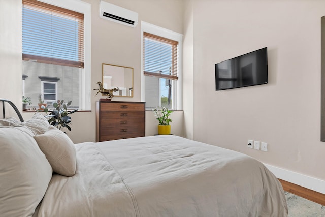 4 Coggswell St Unit 2, Stonington, CT 06379 - bedroom featuring an AC wall unit, wood finished floors, and baseboards