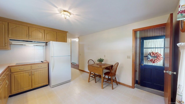 14 Winding Ln, Enfield, CT 06082 - kitchen featuring freestanding refrigerator, under cabinet range hood, baseboards, light flooring, and light countertops