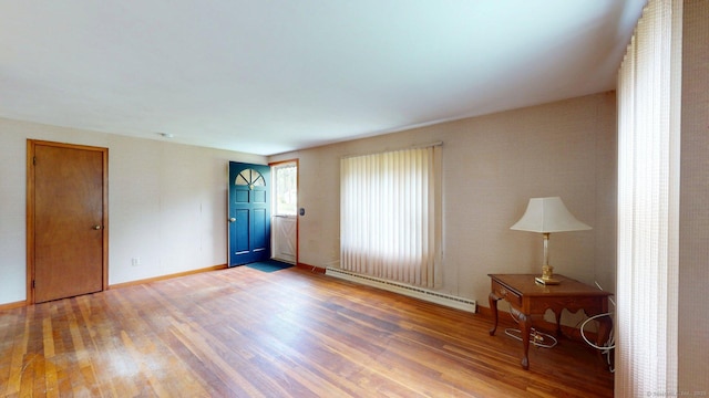 14 Winding Ln, Enfield, CT 06082 - unfurnished room featuring a baseboard heating unit, light wood-style flooring, and baseboards