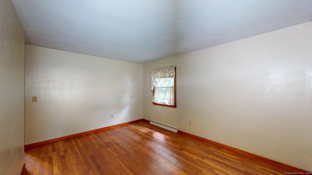 14 Winding Ln, Enfield, CT 06082 - empty room with a baseboard heating unit, wood finished floors, and baseboards