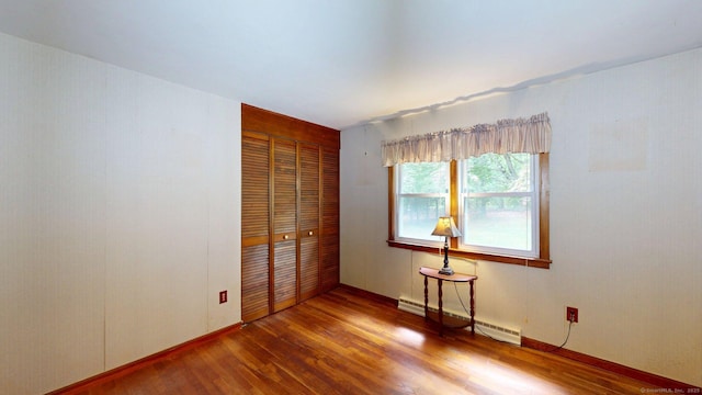 14 Winding Ln, Enfield, CT 06082 - unfurnished bedroom with baseboard heating, wood finished floors, a closet, and baseboards