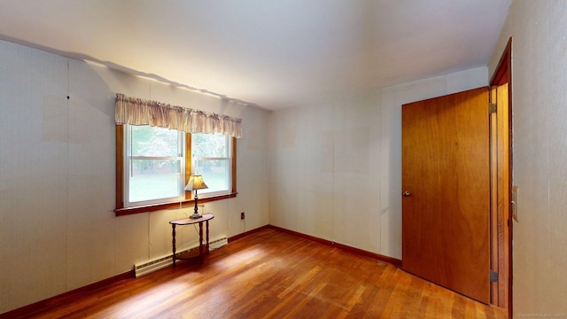 14 Winding Ln, Enfield, CT 06082 - spare room featuring a baseboard radiator and wood finished floors