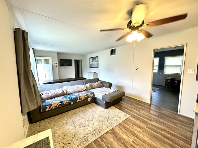living room featuring a ceiling fan, wood finished floors, and baseboards