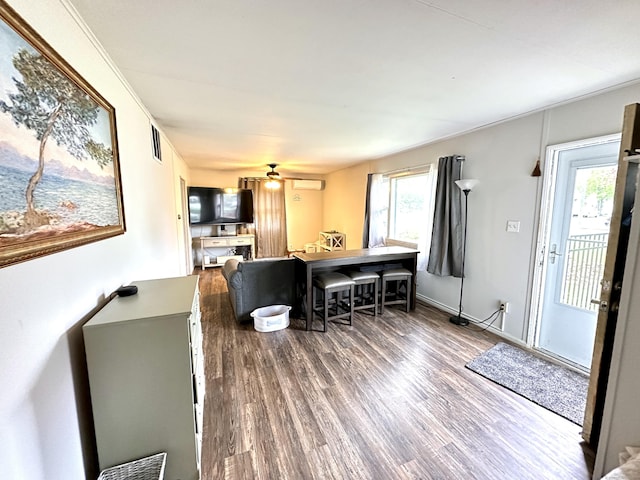 dining space with wood finished floors and a ceiling fan