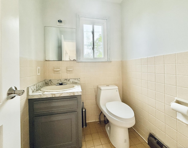22 Palmer Ave, Stamford, CT 06902 - half bath featuring tile walls, toilet, vanity, wainscoting, and tile patterned flooring