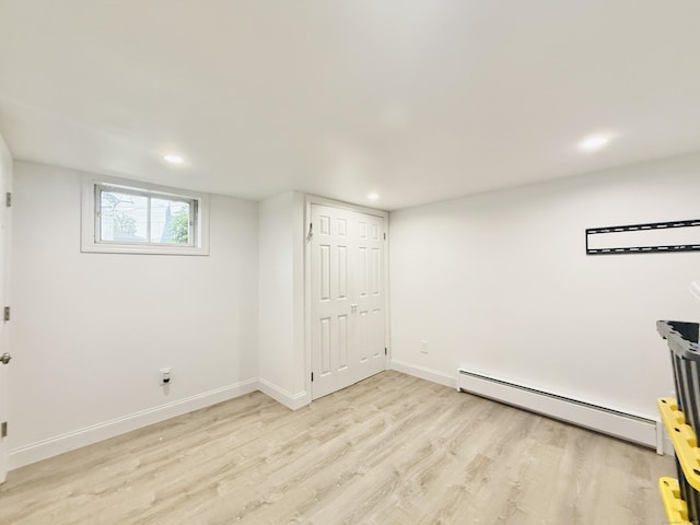 22 Palmer Ave, Stamford, CT 06902 - basement with a baseboard radiator, light wood-type flooring, recessed lighting, and baseboards