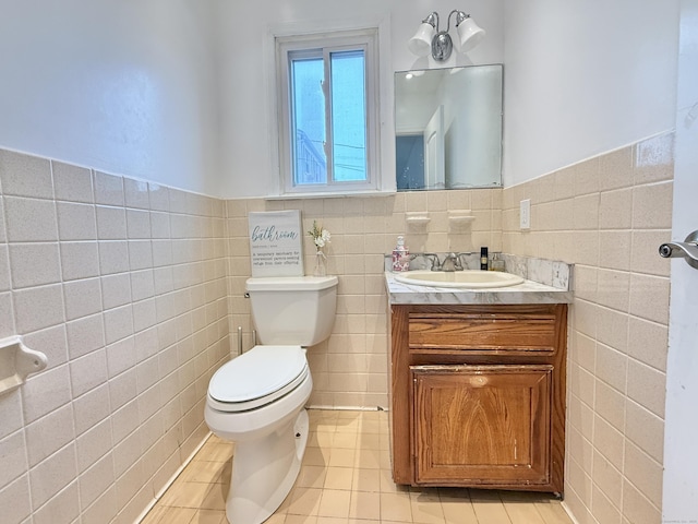 22 Palmer Ave, Stamford, CT 06902 - half bathroom with tile walls, vanity, toilet, a wainscoted wall, and tile patterned flooring
