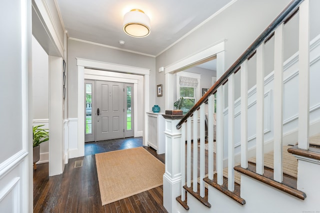 foyer featuring stairway, ornamental molding, and dark wood-style floors
