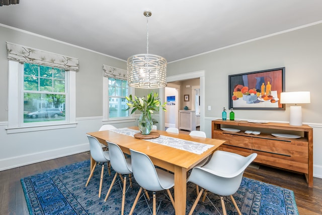 dining area with wood finished floors, a chandelier, crown molding, and baseboards