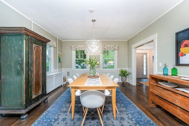 dining space with wood finished floors, healthy amount of natural light, wainscoting, crown molding, and a chandelier