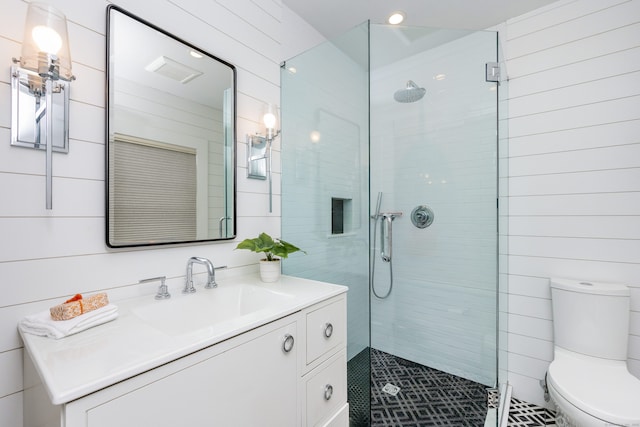 bathroom with tiled shower, vanity, toilet, recessed lighting, and tile patterned flooring