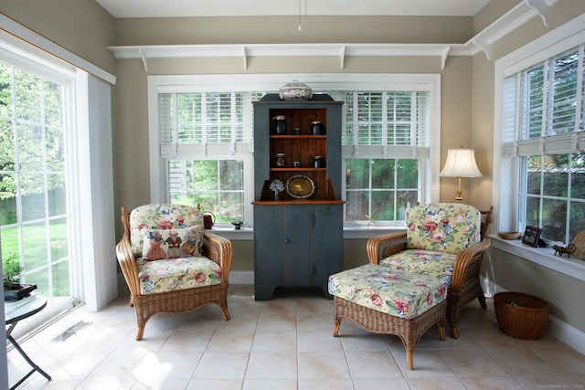 living area with healthy amount of natural light, light tile patterned flooring, and baseboards