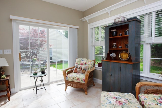 sitting room with baseboards and light tile patterned flooring