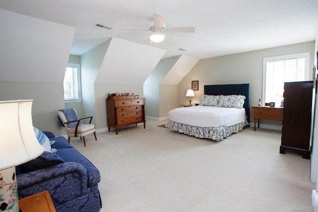 carpeted bedroom featuring vaulted ceiling, ceiling fan, and baseboards