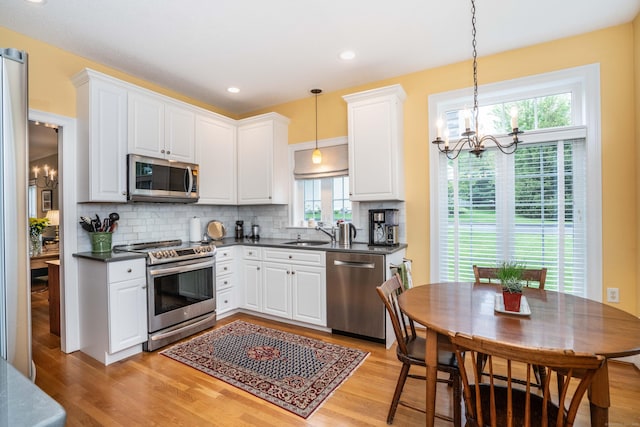 2 Plum Tree Cir, Farmington, CT 06032 - kitchen with appliances with stainless steel finishes, a chandelier, a sink, dark countertops, and recessed lighting