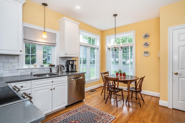 2 Plum Tree Cir, Farmington, CT 06032 - kitchen featuring stainless steel dishwasher, a chandelier, dark countertops, and light wood-style flooring