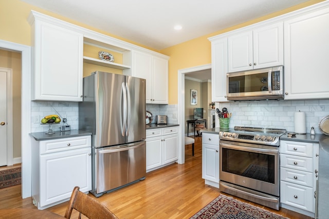 2 Plum Tree Cir, Farmington, CT 06032 - kitchen with appliances with stainless steel finishes, dark countertops, light wood-type flooring, and white cabinetry