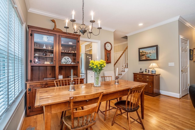 2 Plum Tree Cir, Farmington, CT 06032 - dining room with plenty of natural light, light wood-style flooring, stairs, a chandelier, and crown molding