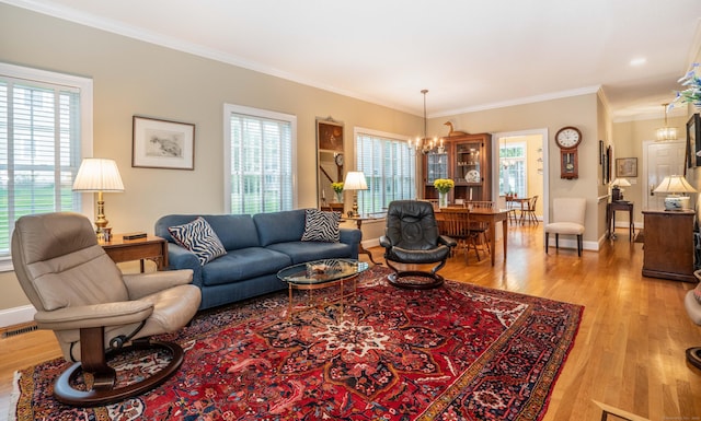 2 Plum Tree Cir, Farmington, CT 06032 - living area with a chandelier, wood finished floors, crown molding, and baseboards
