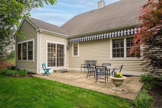 2 Plum Tree Cir, Farmington, CT 06032 - rear view of house with a shingled roof, a patio area, a yard, and a chimney