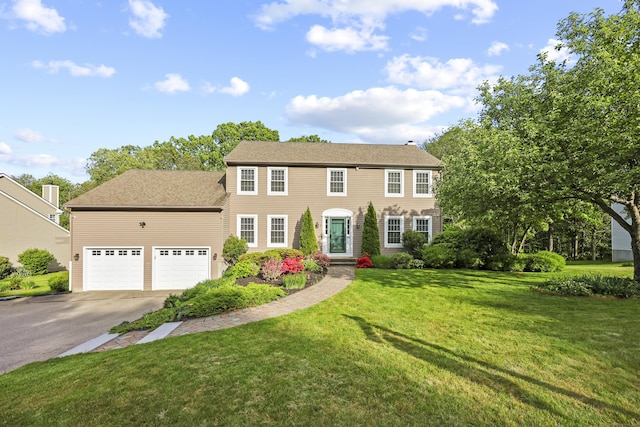 5 Nutmeg Ln, East Hampton, CT 06424 - colonial house featuring asphalt driveway, an attached garage, and a front lawn