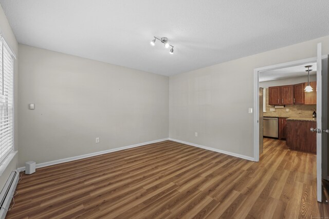 5 Nutmeg Ln, East Hampton, CT 06424 - unfurnished room with baseboard heating, dark wood finished floors, and baseboards