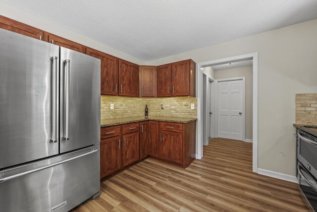 5 Nutmeg Ln, East Hampton, CT 06424 - kitchen with stainless steel appliances, light wood-type flooring, backsplash, and stone counters