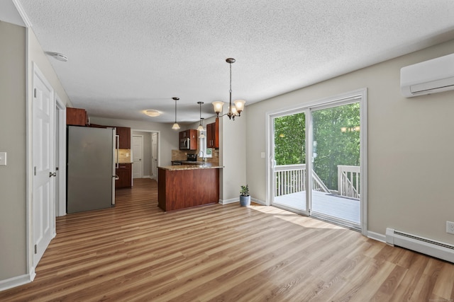 5 Nutmeg Ln, East Hampton, CT 06424 - kitchen featuring freestanding refrigerator, wood finished floors, a sink, a textured ceiling, and a wall unit AC