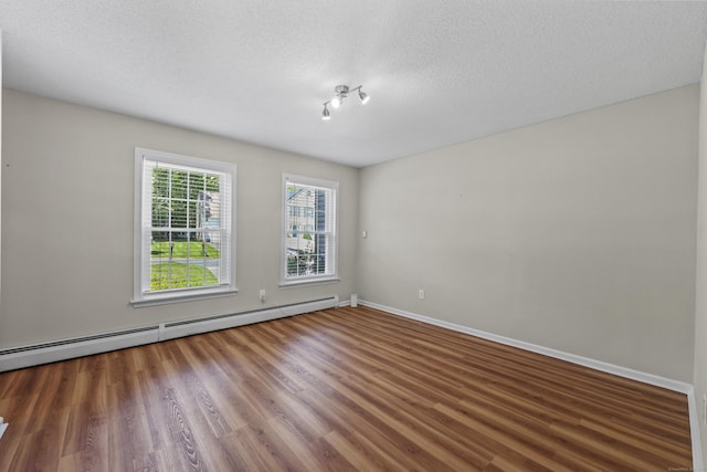 5 Nutmeg Ln, East Hampton, CT 06424 - spare room featuring a baseboard radiator, wood finished floors, a textured ceiling, and baseboards