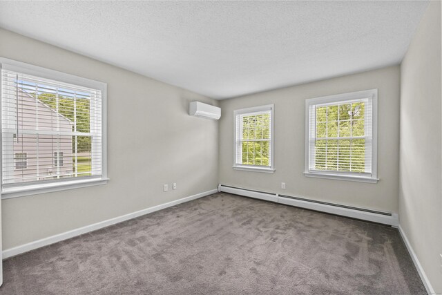 5 Nutmeg Ln, East Hampton, CT 06424 - carpeted spare room with a baseboard heating unit, a wall mounted air conditioner, a textured ceiling, and baseboards