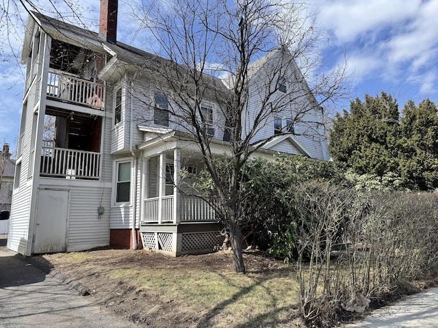 485 Laurel Ave, Bridgeport, CT 06605 - view of side of property featuring a balcony, a porch, and a chimney