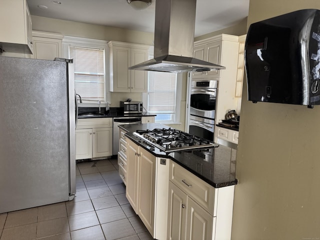485 Laurel Ave, Bridgeport, CT 06605 - kitchen with appliances with stainless steel finishes, island range hood, white cabinetry, a sink, and tile patterned flooring