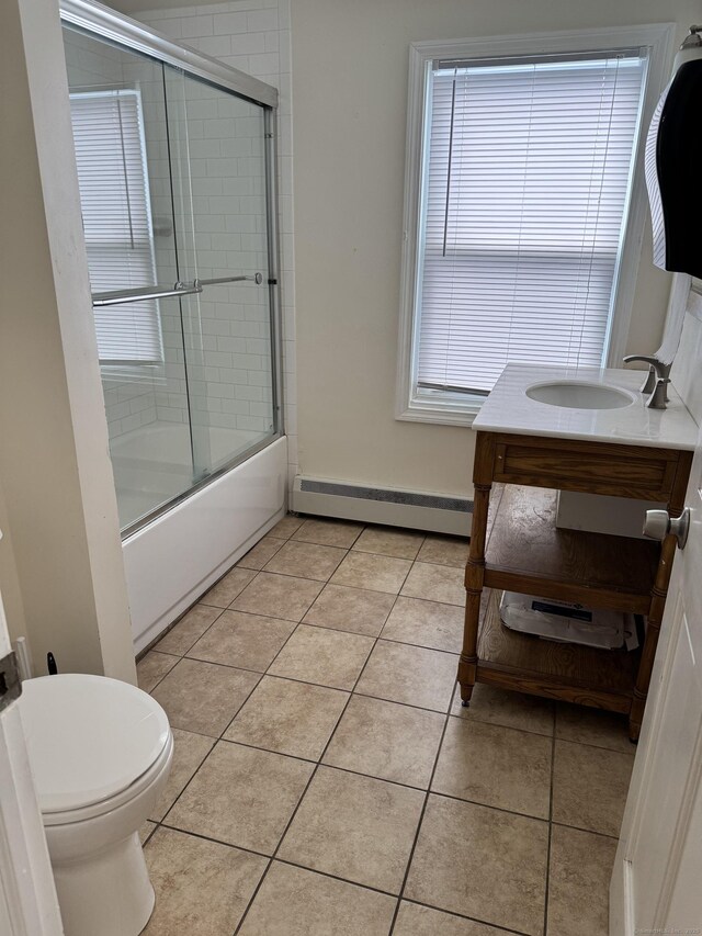 485 Laurel Ave, Bridgeport, CT 06605 - full bathroom with a baseboard heating unit, tile patterned floors, toilet, and combined bath / shower with glass door