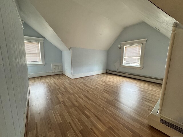 485 Laurel Ave, Bridgeport, CT 06605 - bonus room with a baseboard radiator, wood finished floors, vaulted ceiling, and healthy amount of natural light