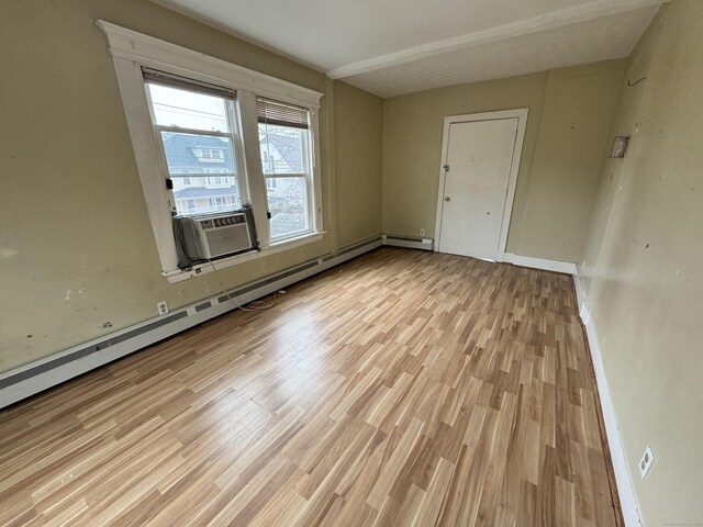 485 Laurel Ave, Bridgeport, CT 06605 - empty room featuring baseboard heating, light wood finished floors, cooling unit, and baseboards