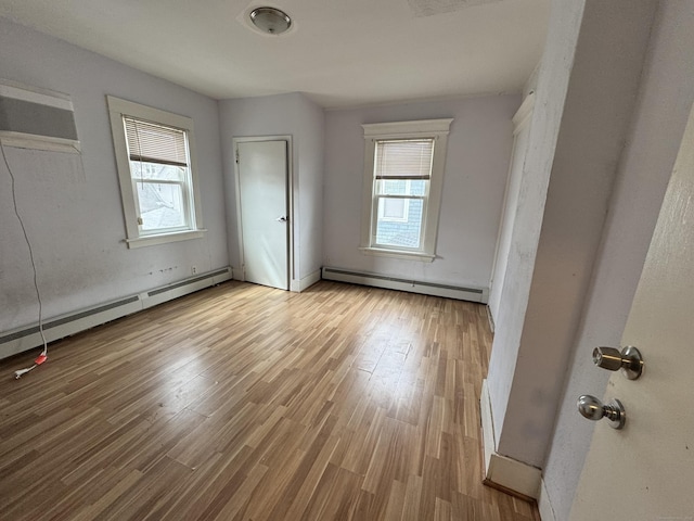 485 Laurel Ave, Bridgeport, CT 06605 - unfurnished bedroom with baseboard heating and wood finished floors