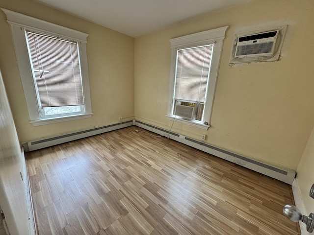 485 Laurel Ave, Bridgeport, CT 06605 - empty room with plenty of natural light, an AC wall unit, cooling unit, and wood finished floors