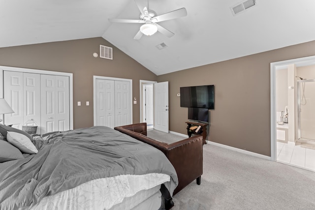 bedroom featuring two closets, carpet floors, high vaulted ceiling, connected bathroom, and baseboards