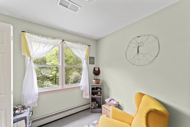 sitting room featuring a baseboard radiator and carpet