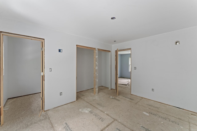 unfurnished bedroom with multiple closets