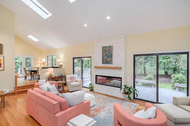 22 Kristy Dr, Bethel, CT 06801 - living room featuring light wood-style floors, healthy amount of natural light, a stone fireplace, a skylight, and recessed lighting