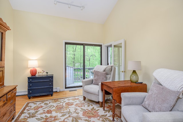 22 Kristy Dr, Bethel, CT 06801 - sitting room featuring baseboard heating, a baseboard heating unit, light wood-type flooring, track lighting, and high vaulted ceiling