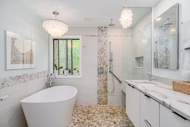 22 Kristy Dr, Bethel, CT 06801 - bathroom with a chandelier, tile walls, walk in shower, a soaking tub, and vanity