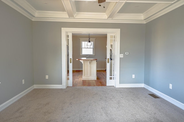 carpeted spare room featuring crown molding, french doors, beam ceiling, coffered ceiling, and baseboards